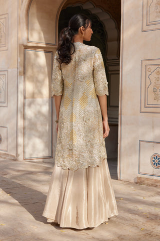 Back view of beige champagne embroidered jacket with scalloped hem and flared skirt by Osaa by Adarsh at Mrs. G