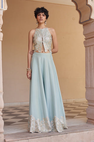 Full-length front view of tea green halter top and wide-leg flared pants with embroidered hem by Osaa by Adarsh at Mrs. G