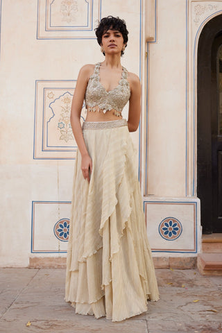 Full-length front view of beige champagne halter top with 3D flowers and tiered frill skirt by Osaa by Adarsh at Mrs. G