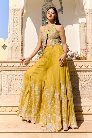 Three-quarter view of canary yellow garara flaring to a scalloped embroidered hem by Osaa by Adarsh at Mrs. G
