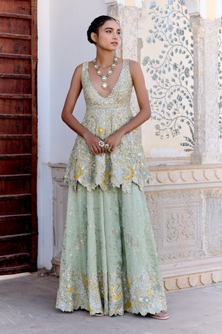 Front view of sage peplum garara set with a deep V-neck zardozi top and long necklace by Osaa by Adarsh at Mrs. G