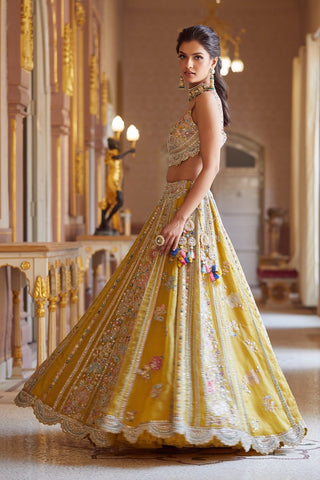 Side twirl view of honey gold lehenga with scalloped silver hem and tassel latkan by Osaa by Adarsh at Mrs. G