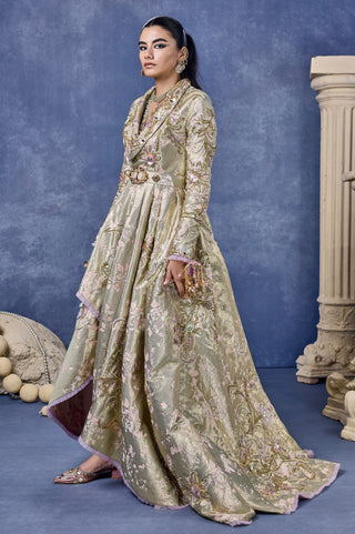 Side view of the sage green gown with an asymmetric ruffle-edged hem at Mrs. G