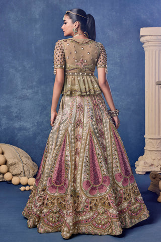 Back view of the green sheer peplum blouse and embroidered lehenga at Mrs. G