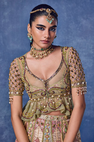 Close-up of the V-neck, lattice-beaded sleeves and ruffled peplum on the green blouse at Mrs. G