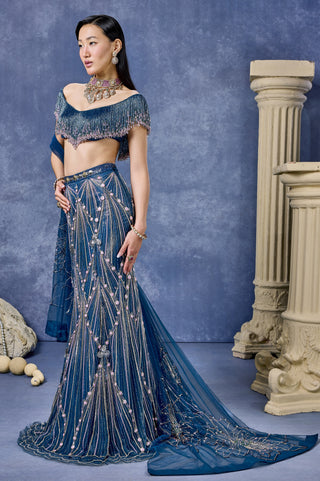 Side view of the teal fish cut lehenga with a trailing dupatta at Mrs. G