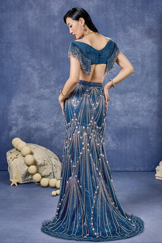 Back view of the teal lehenga set with a draped dupatta and fish cut hem at Mrs. G