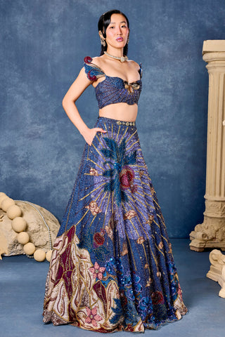 Three-quarter view of the blue beaded corset and gold ray embroidered skirt at Mrs. G