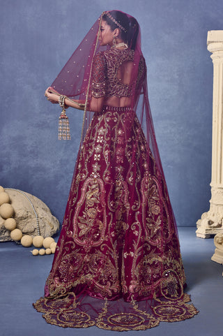 Back view of the maroon lehenga set with a net veil worn over the head for styling at Mrs. G