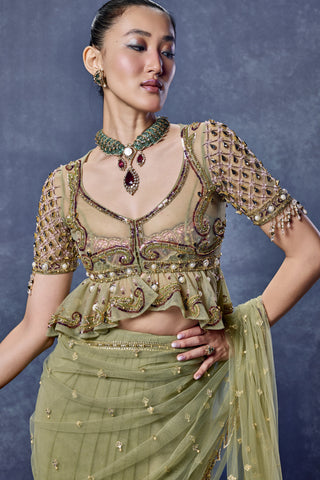 Close-up of the embroidered peplum blouse and V-neck on the sage green saree set at Mrs. G