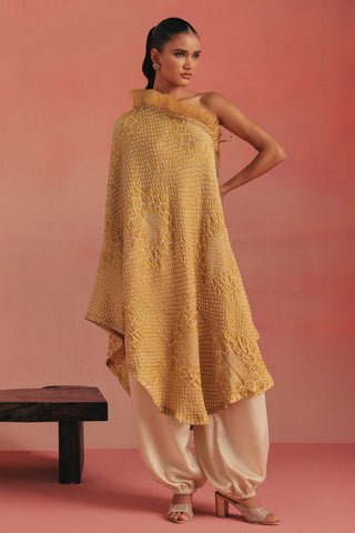 Full-length front view of the one-shoulder bandhani dress and ivory barrel pants, yellow ziya one-shoulder kurta set by Twenty Nine at Mrs. G