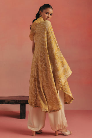 Back-three-quarter view of the open back and draped hem, yellow ziya one-shoulder kurta set by Twenty Nine at Mrs. G
