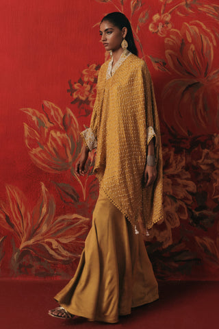 Full-length walking view of the kaftan and flared pants, yellow ziya tassel kaftan set by Twenty Nine at Mrs. G