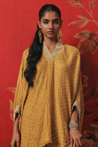 Waist-up front view of the V-neck kaftan with a trimmed neckline, yellow ziya tassel kaftan set by Twenty Nine at Mrs. G