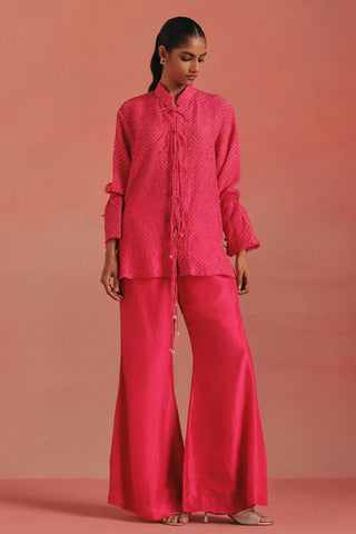 Full-length front view of the bandhani tunic and flared bellbottoms, bubblegum pink ziya bandhani tie-up sharara set by Twenty Nine at Mrs. G