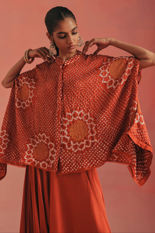 Waist-up view with both hands at the collar and the tunic drop sides spread, burnt orange ziya band collar dhoti set by Twenty Nine at Mrs. G