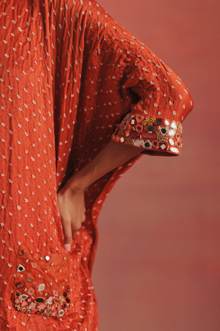 Close-up of the mirror work cuff and pocket on the cape sleeve, burnt orange ziya cape top with dhoti by Twenty Nine at Mrs. G