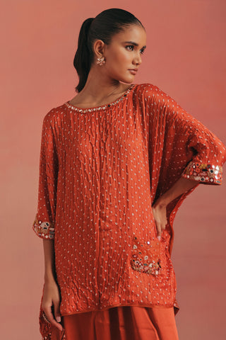Waist-up view of the round neckline and cuffed sleeve, burnt orange ziya cape top with dhoti by Twenty Nine at Mrs. G