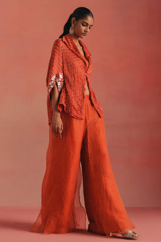 Full-length side view of the jacket and organza-layered palazzos, burnt orange ziya mirrorwork jacket set by Twenty Nine at Mrs. G