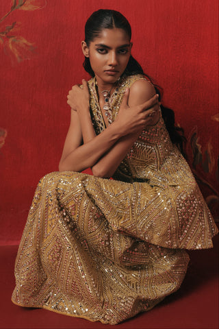 Seated view of the jacket and sharara with mirror work, citrus yellow ziya peplum sharara set by Twenty Nine at Mrs. G