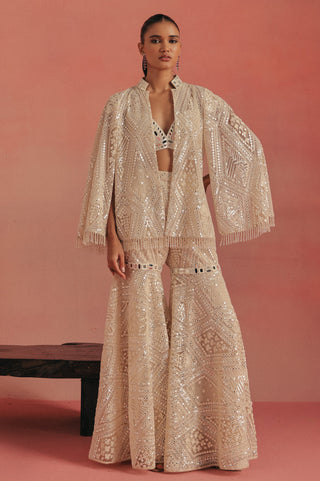 Full-length front view of the cape-sleeve jacket and wide-leg sharara, ivory ziya mirrorwork sharara set by Twenty Nine at Mrs. G