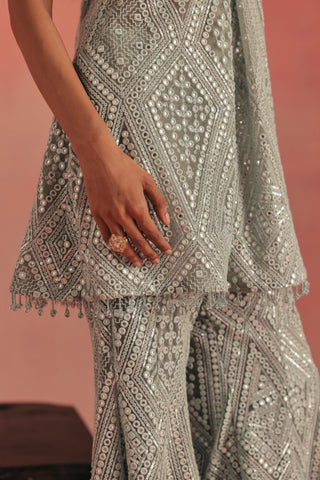 Close-up of the mirror work and tassel hem on the tunic, blue ziya cross strap sharara set by Twenty Nine at Mrs. G