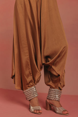 Close-up of the tapered dhoti ankle with cuff ankle jewelry, natural gold ziya afghani dhoti set by Twenty Nine at Mrs. G