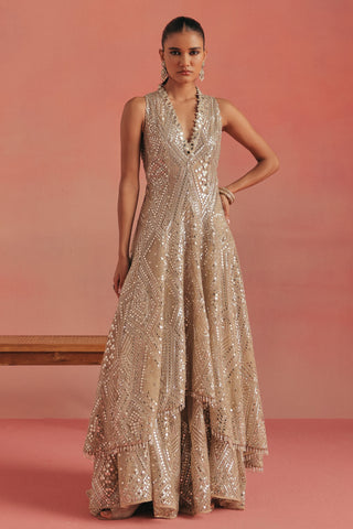 Full-length front view of the sleeveless hi-low jacket beside a wooden bench, gold ziya high low jacket set by Twenty Nine at Mrs. G