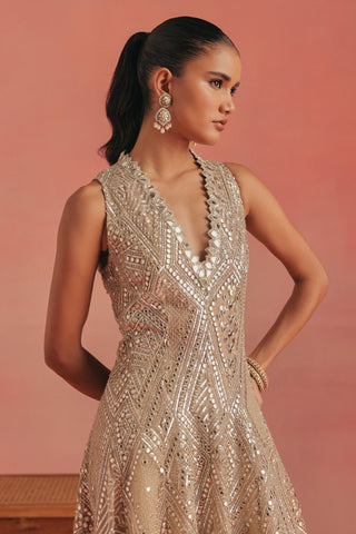Three-quarter view of the jacket with a hand on the hip, gold ziya high low jacket set by Twenty Nine at Mrs. G