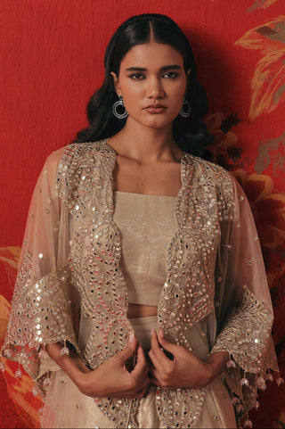 Waist-up front view of the cape and bandeau against a red backdrop, pearl silver ziya cape set by Twenty Nine at Mrs. G